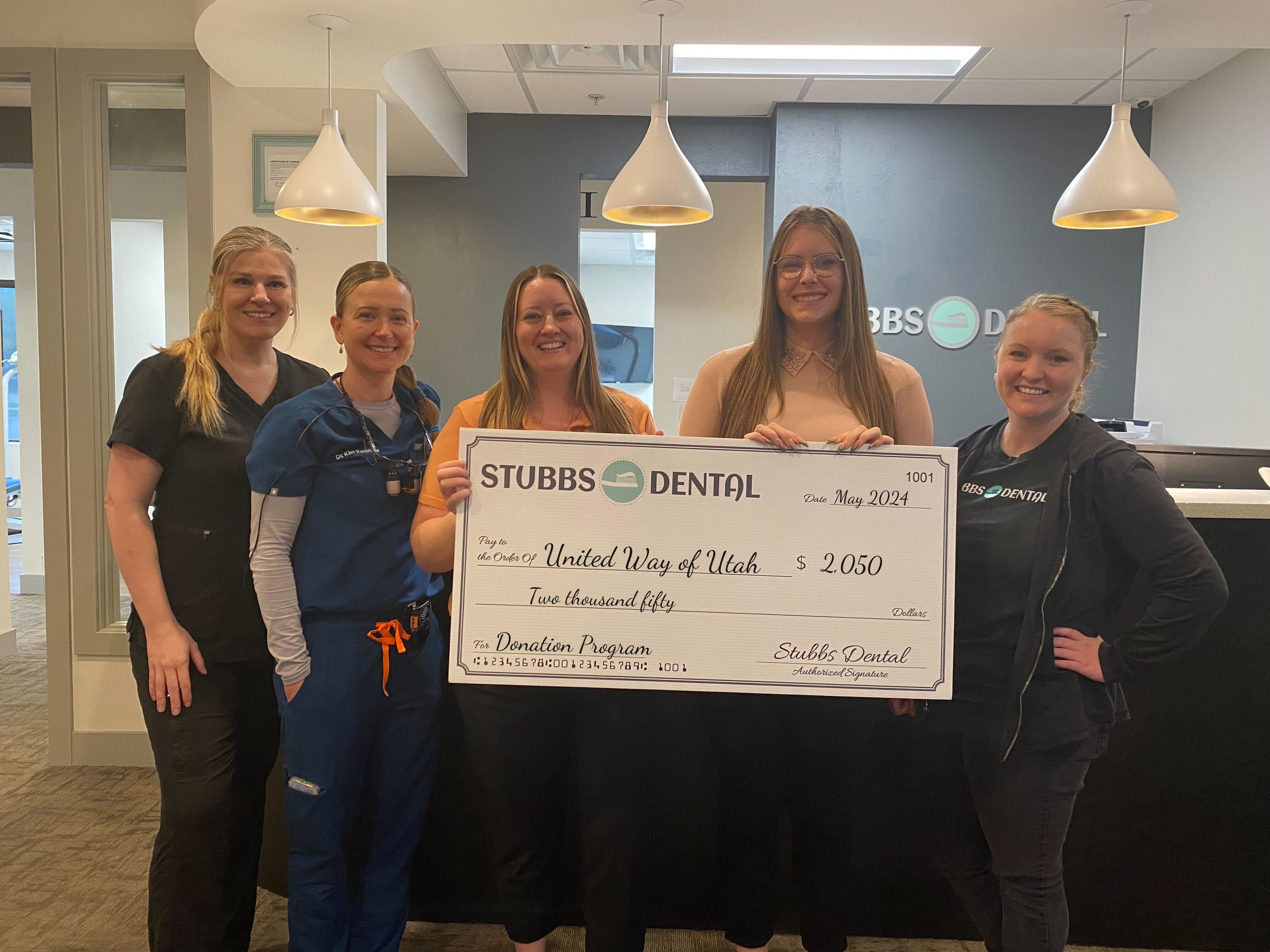 Stubbs Dental presents donation check to Autism Wellness Center of Utah