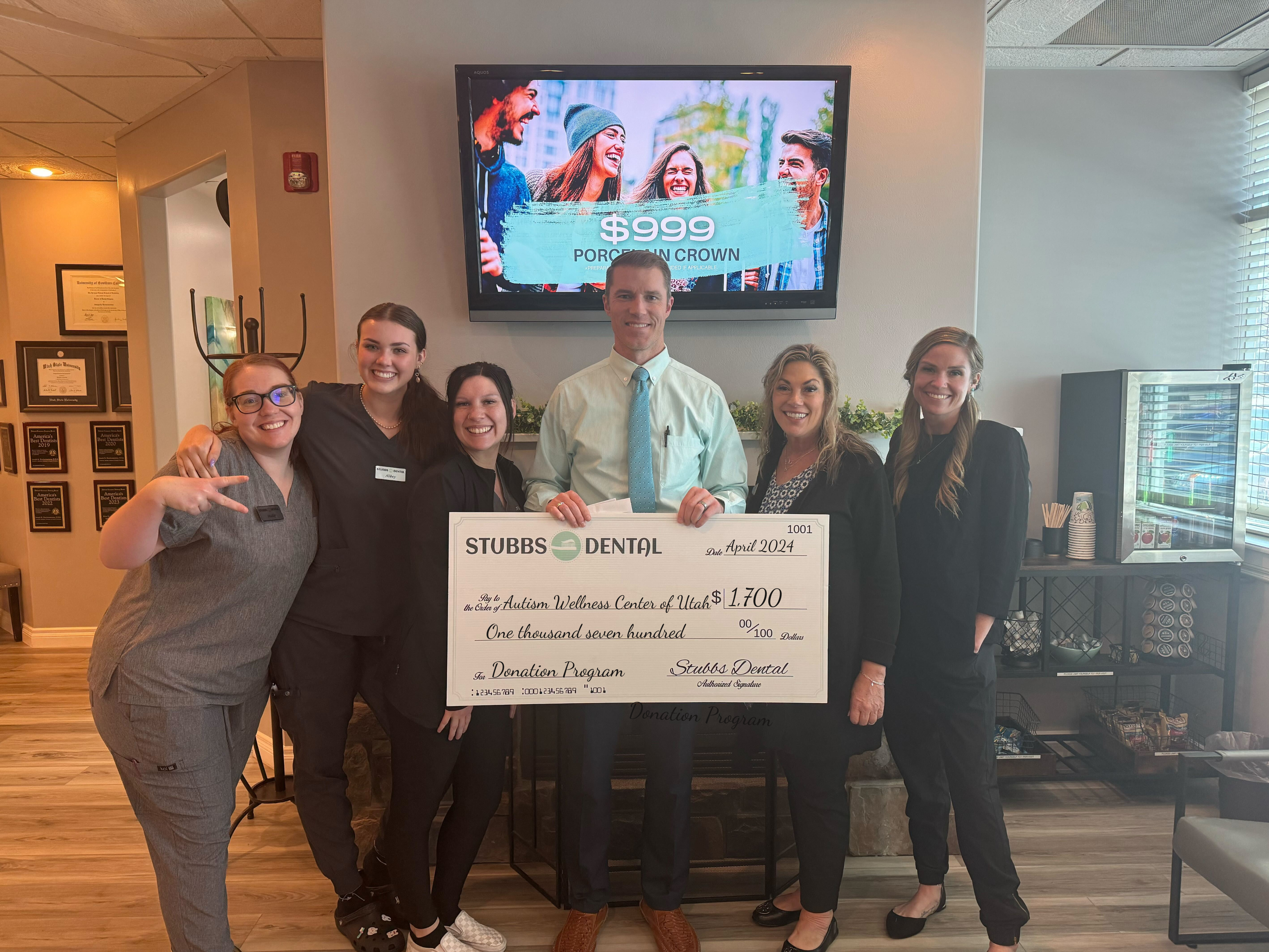 Stubbs Dental presents donation check to Autism Wellness Center of Utah